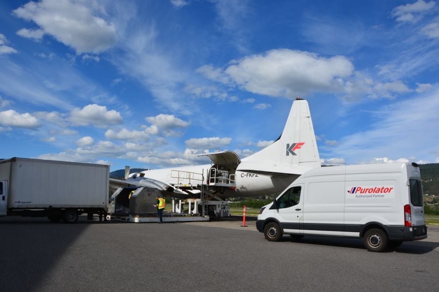 <who>Photo credit: KF Aerospace</who>Cargo is loaded onto a Purolator plane at KF Aerospace in Kelowna.